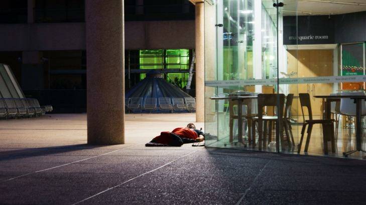 A homeless man spends the night outside the State Library of NSW in Sydney's CBD. Photo: Christopher Pearce