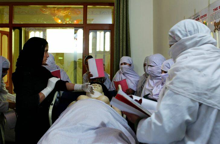 URUZGAN- DAILY LIFE
Midwife of 2 years and now teacher Rugol Faqari  (left) instructs the first group of female midwifery students at The Midwifery School in Tarin Kowt. The students are 6months into their 2 year course that is funded and established by the Australian branch of NGO Save The Children. On completing their courses they will return to their villages.Tarin Kowt, Uruzgan Province, Afghanistan. 30th January, 2013. Photo: Kate Geraghty