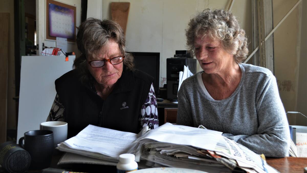 CALL FOR INQUIRY: Jenny Bellinger and Lin Simpson pore over documents collected over their seven-year battle with TasWater. Picture: Frances Vinall