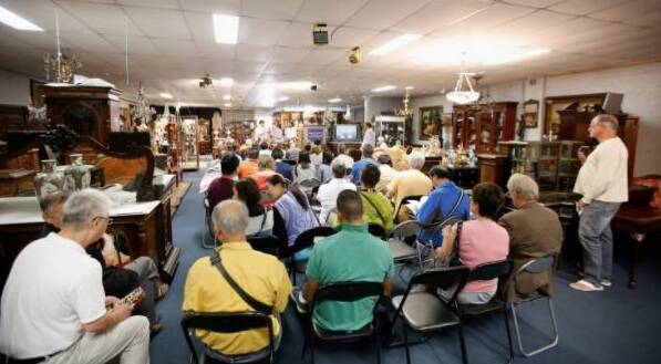 Christian McCann auction off items at a French furniture auction in Melbourne, Victoria. Photo: Darrian Traynor