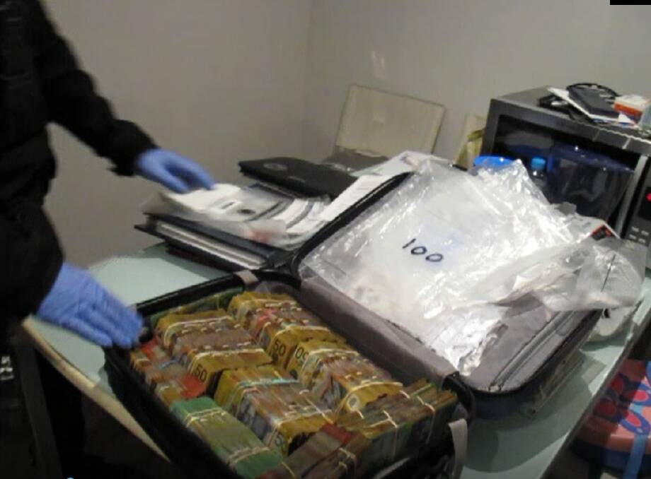 A suitcase containing hundreds of thousands of dollars in cash were seized as part of Operation Ironside. Picture: AFP