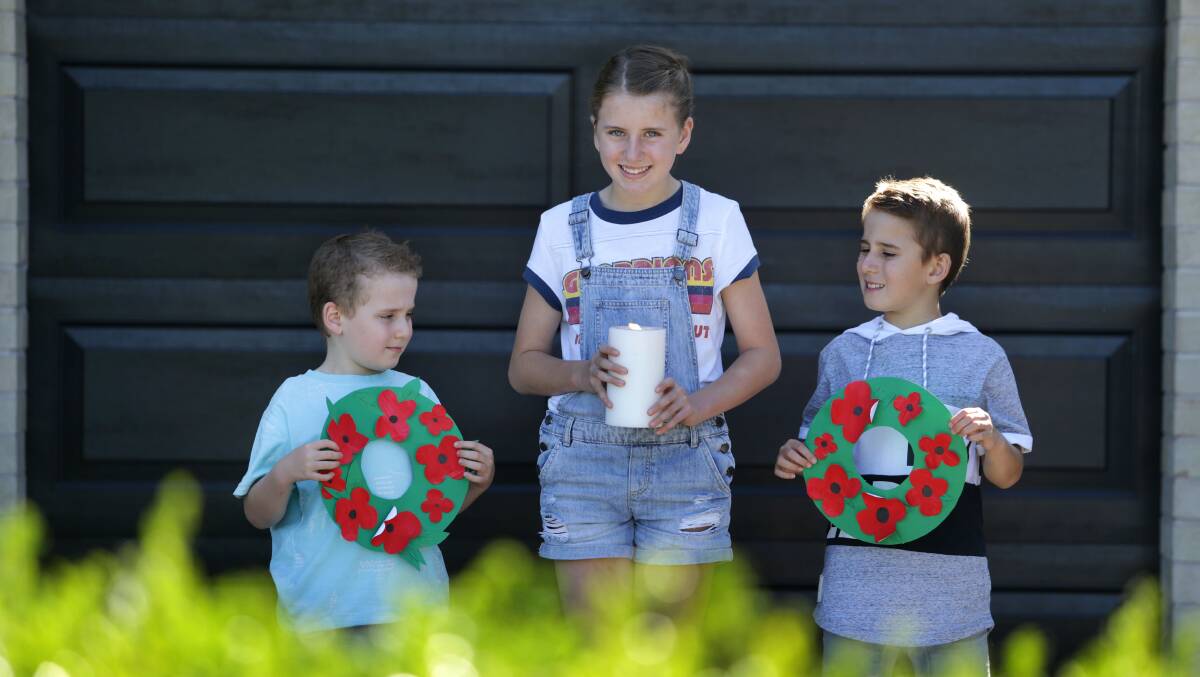 Lest we forget: Zach, Holly and Riley McGuirk, of Lilli Pillli, were among those who took part in Light up the Dawn last year. Picture: John Veeage