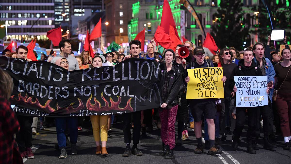Climate change protesters march through the streets of Brisbane in opposition to Adani's proposed Carmichael mine in Queensland. Picture: AAP