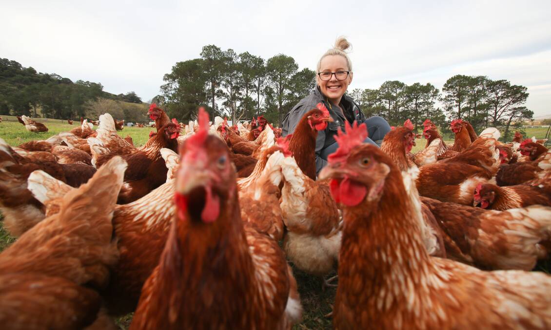 Emily Frost surrounded by hens living the good life at Kareelah Berry Farm. Photos: Adam McLean