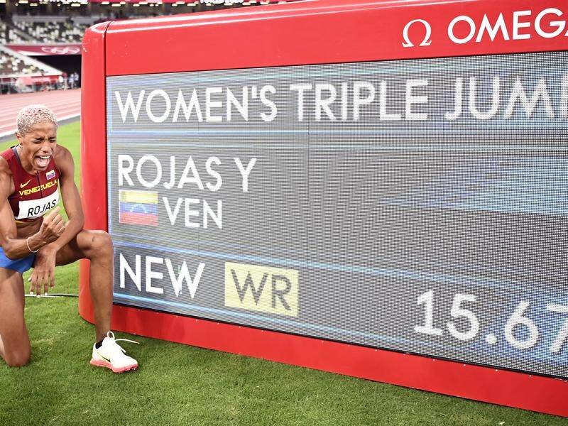 Yulimar Rojas poses with her new triple jump world record of 15.67 metres set in Tokyo.