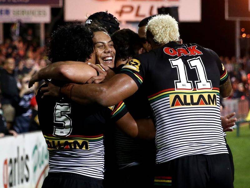 Jarome Luai is engulfed by his Penrith teammates after scoring a try against Canberra.