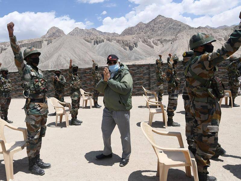 Indian PM Narendra Modi greets soldiers at a base in the remote Ladakh region bordering China.