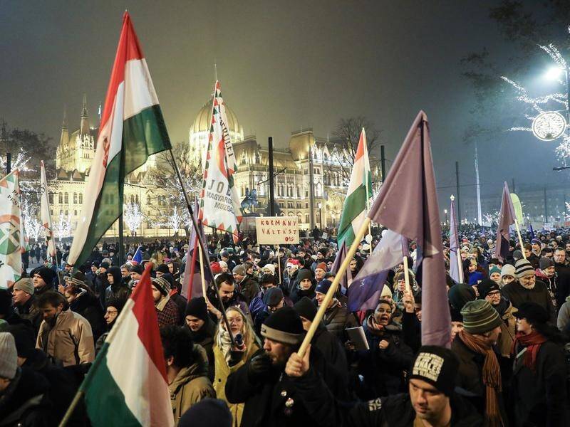 Demonstrators protest Hungary's new "slave law" that allows employers to ask staff to work overtime.