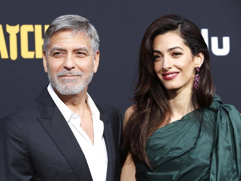The media should be kinder to the Duchess of Sussex now that she's a mother, George Clooney says.