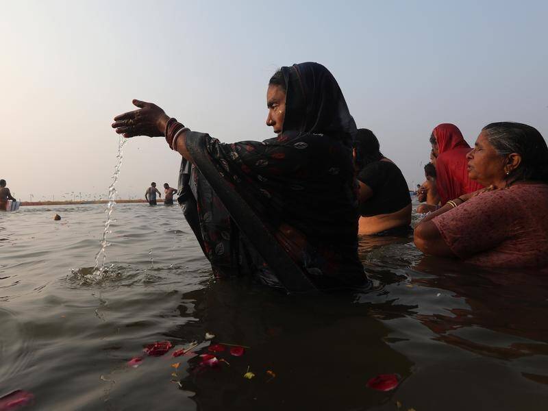 Indian women offer prayers at the Sangam river ahead of the Kumbh Mela festival.