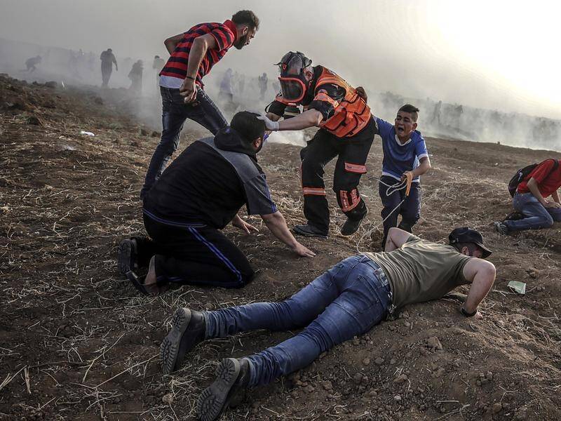 Palestinians have protested again at the Gaza border fence, with dozens wounded by Israeli gunfire.
