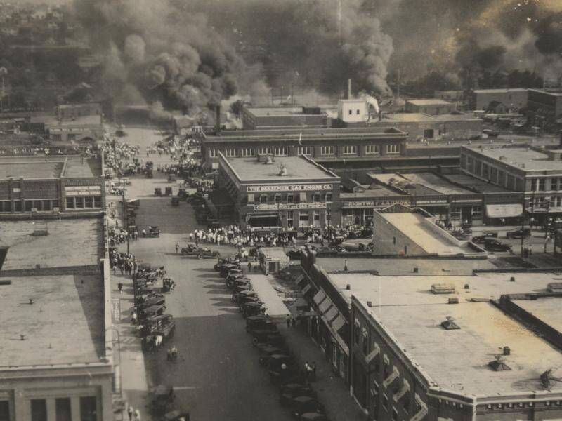 Crowds watch fires during the Tulsa Race Massacre in Oklahoma on June 1, 1921.