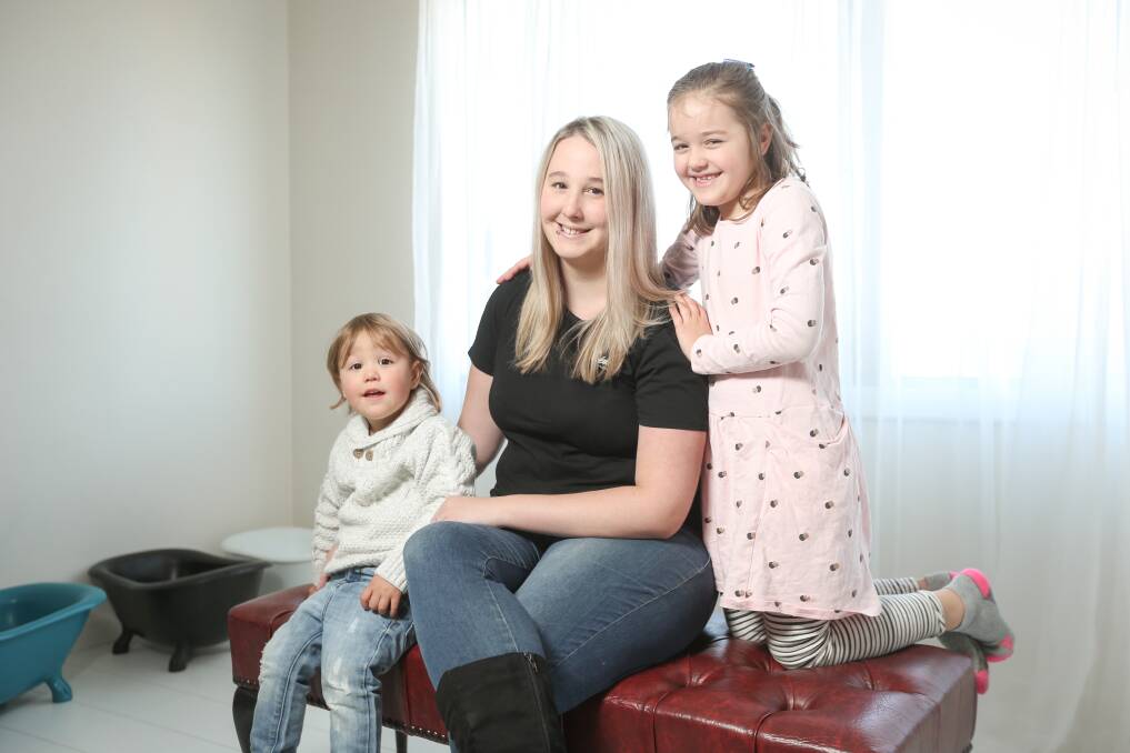 CAPTURING LIFE: Tiffany Phillis of Wonderland Photography with son Ezra, 2, and daughter Lilly, 6, in her Albury studio. Picture: JAMES WILTSHIRE 