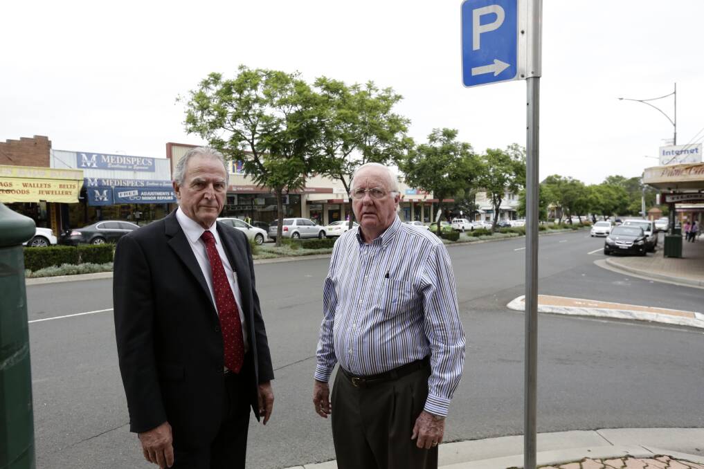 Stop the chop: President of the newly formed Camden Community Alliance Pieter Versluis (left) and secretary Peter Standen at the Oxley Street intersection in Camden where Jacaranda trees will be cut down to make way for traffic lights. Picture: Anna Warr
